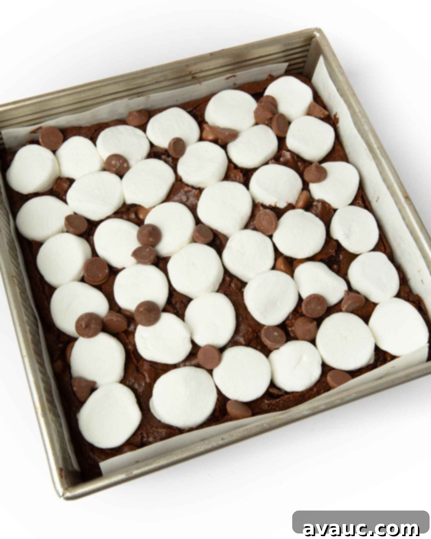 S'mores Brownies 10 Halved marshmallows being gently pressed into a partially baked brownie base.