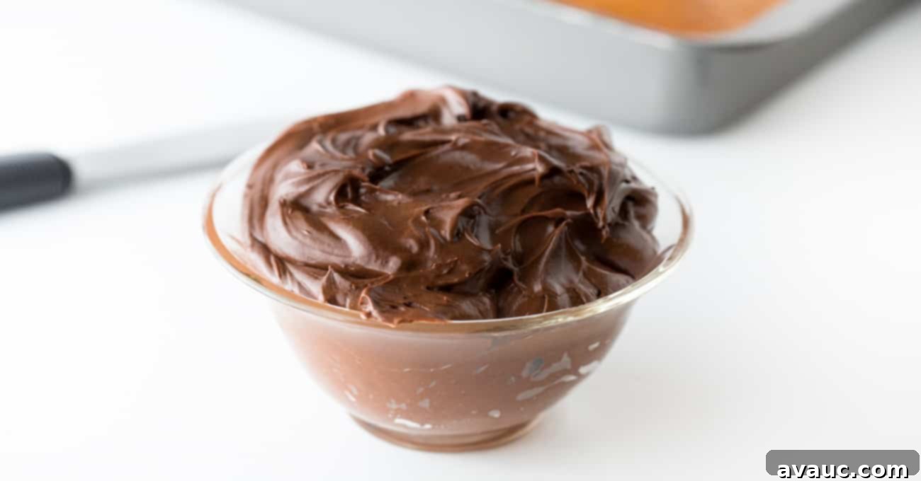 No-Fuss Dirt Cookie Bars 9 Homemade chocolate frosting in a white mixing bowl with a spatula