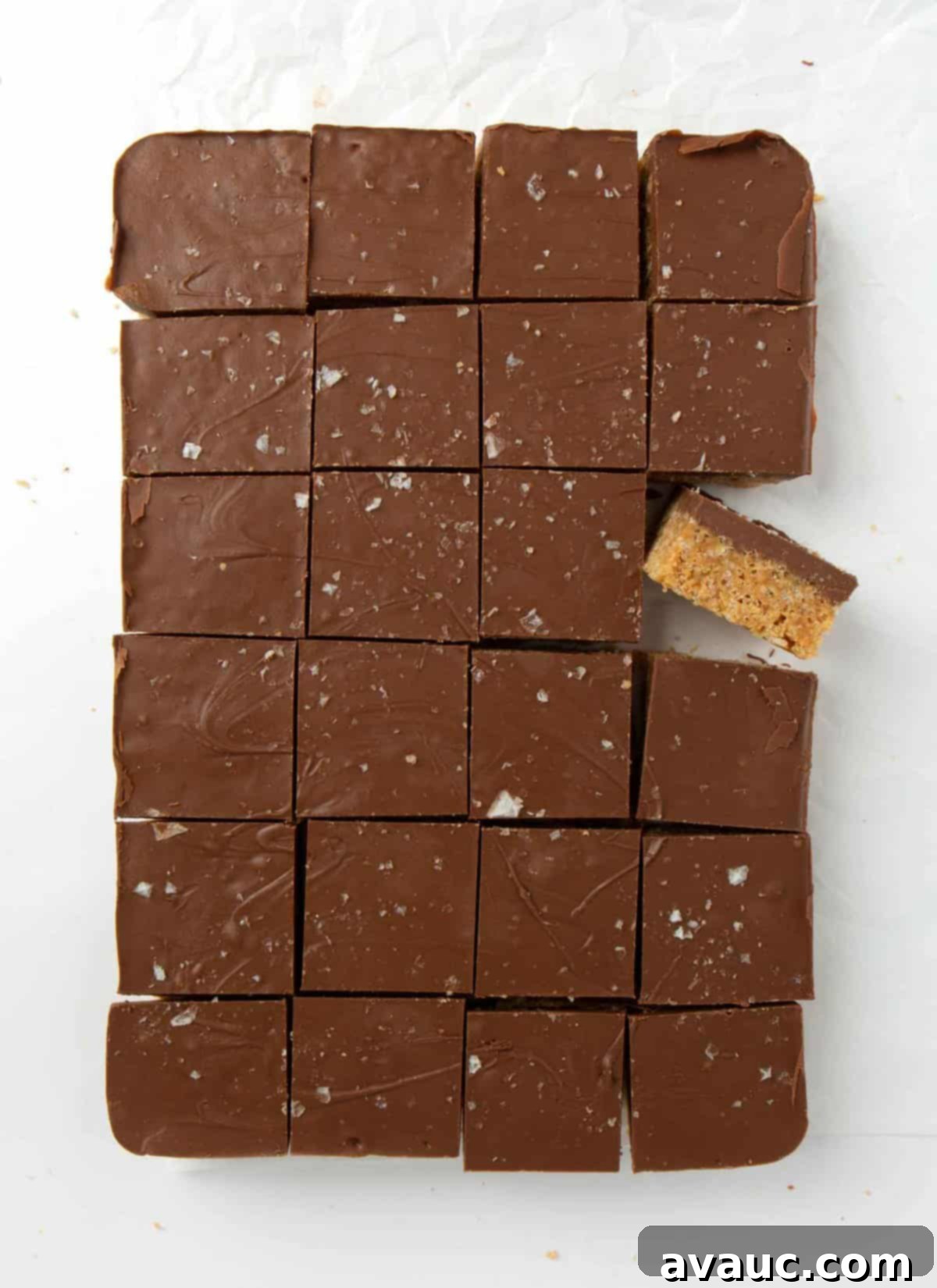 scotcheroos neatly cut into 24 small squares on a cutting board