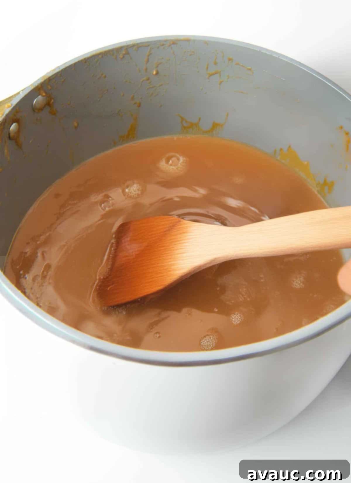 peanut butter, sugar, corn syrup, and butter mixture cooking gently in a saucepan