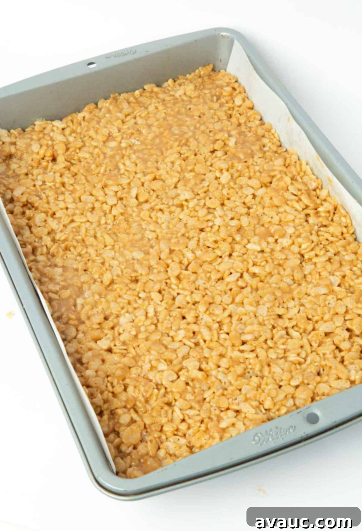 scotcheroo mixture pressed evenly into a 9x13 pan, ready for topping