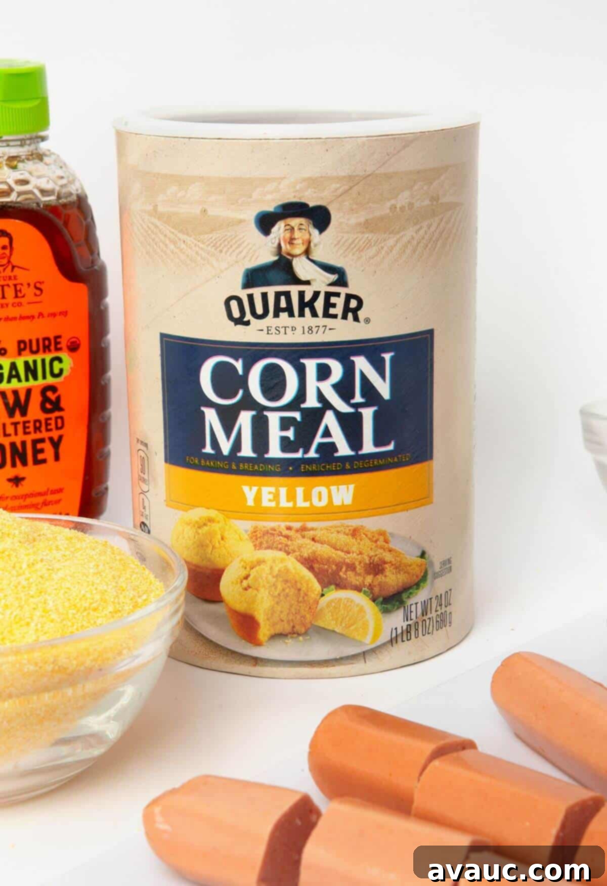 Corn Dog Muffin Poppers 4 All the necessary ingredients laid out on a counter for making mini corn dog muffins: flour, cornmeal, sugar, butter, milk, egg, honey, and hot dogs