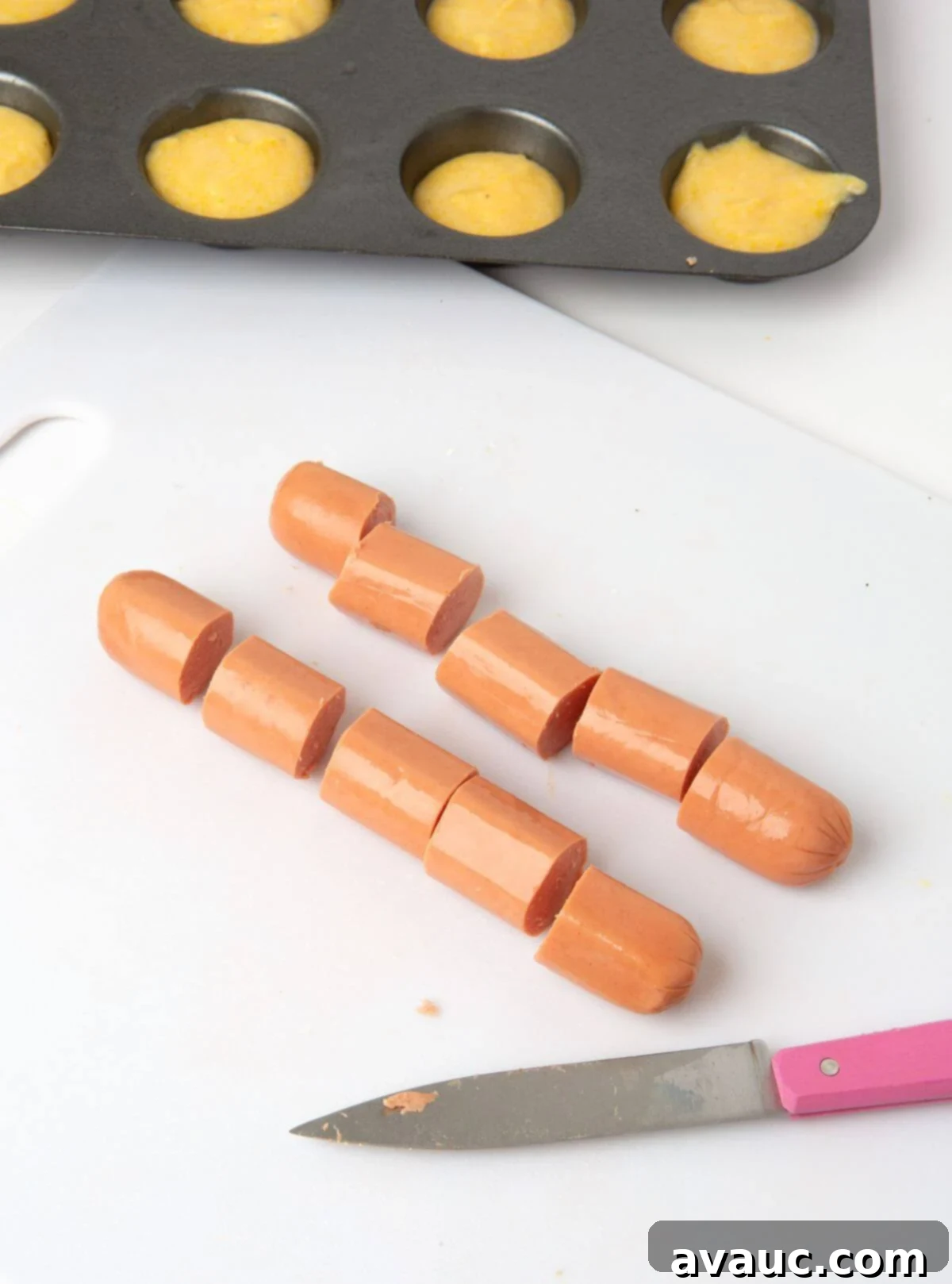 Corn Dog Muffin Poppers 5 A single hot dog neatly cut into 5 equal, bite-sized pieces for mini corn dog muffins
