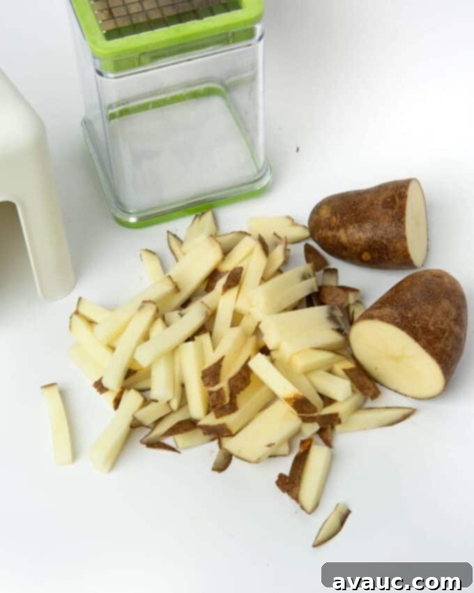 Freshly cut raw potato strips, ready for an ice bath for crispy air fryer french fries