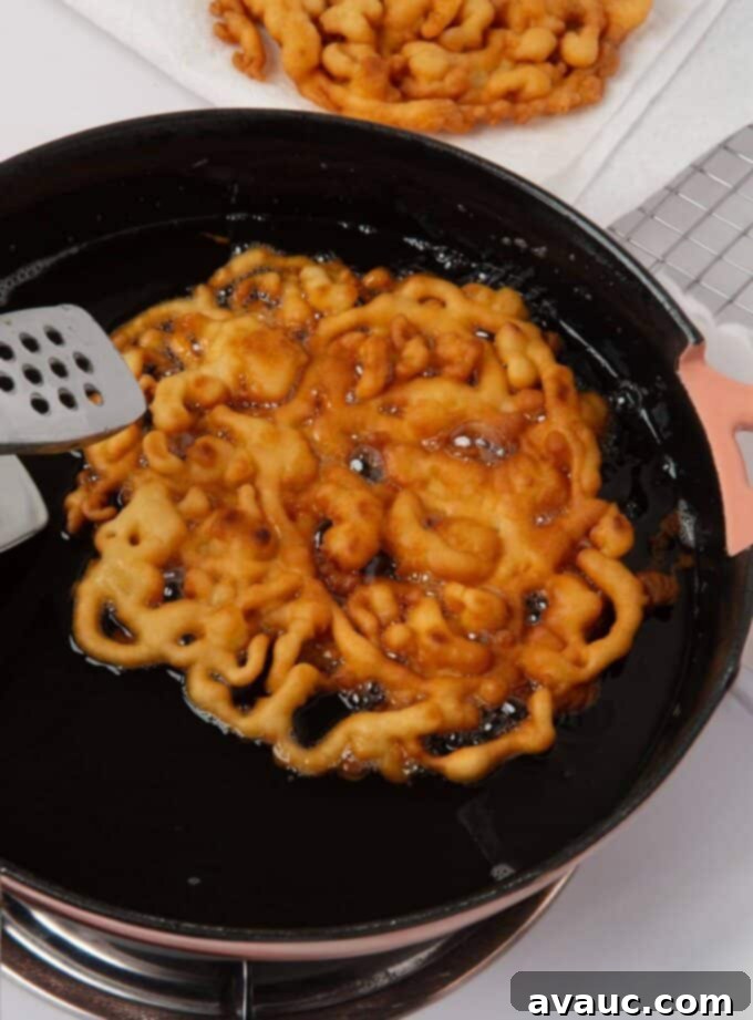 Simple Homemade Funnel Cakes 8 funnel cake frying in oil in skillet