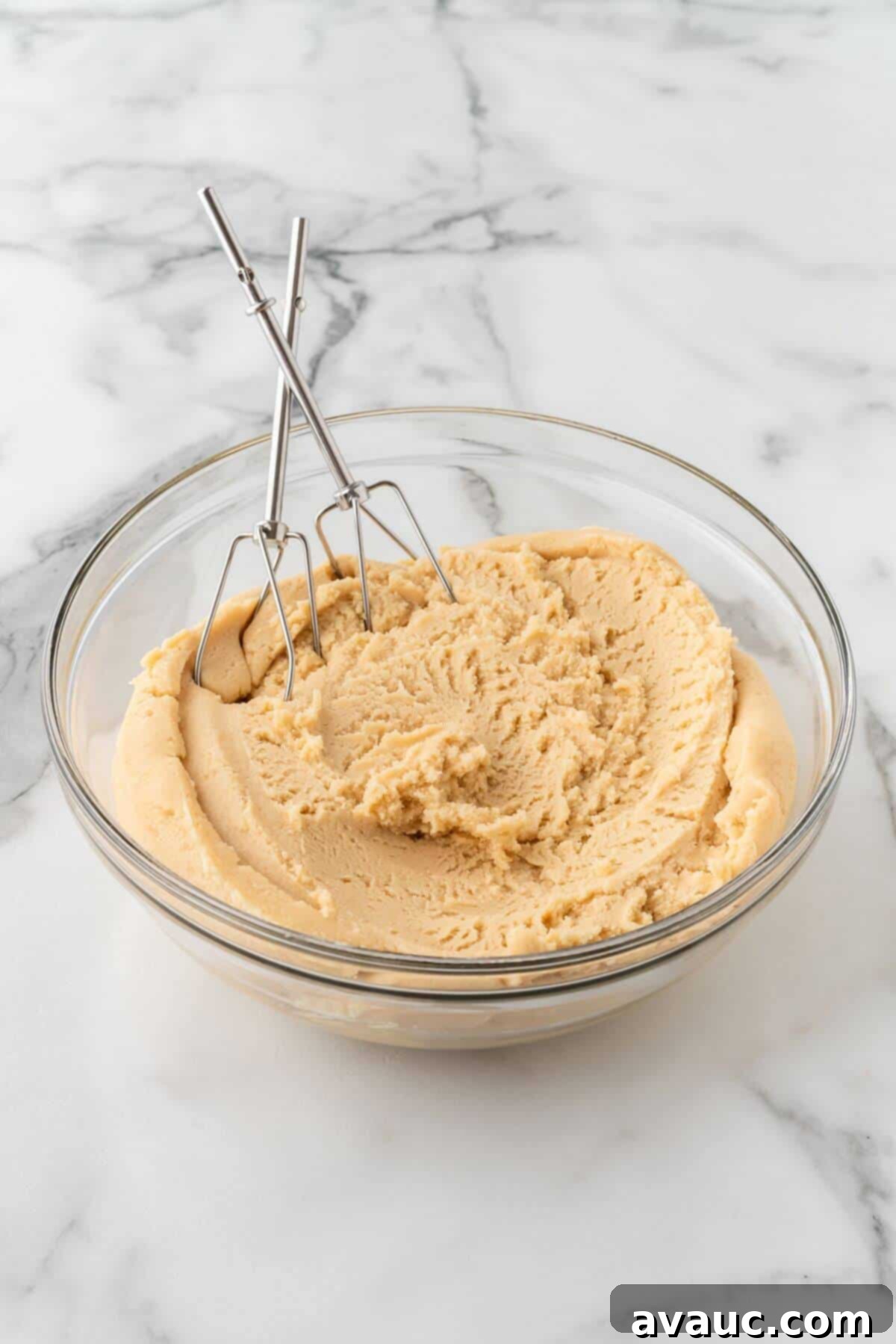 Sugar cookie dough in a glass mixing bowl after mixing