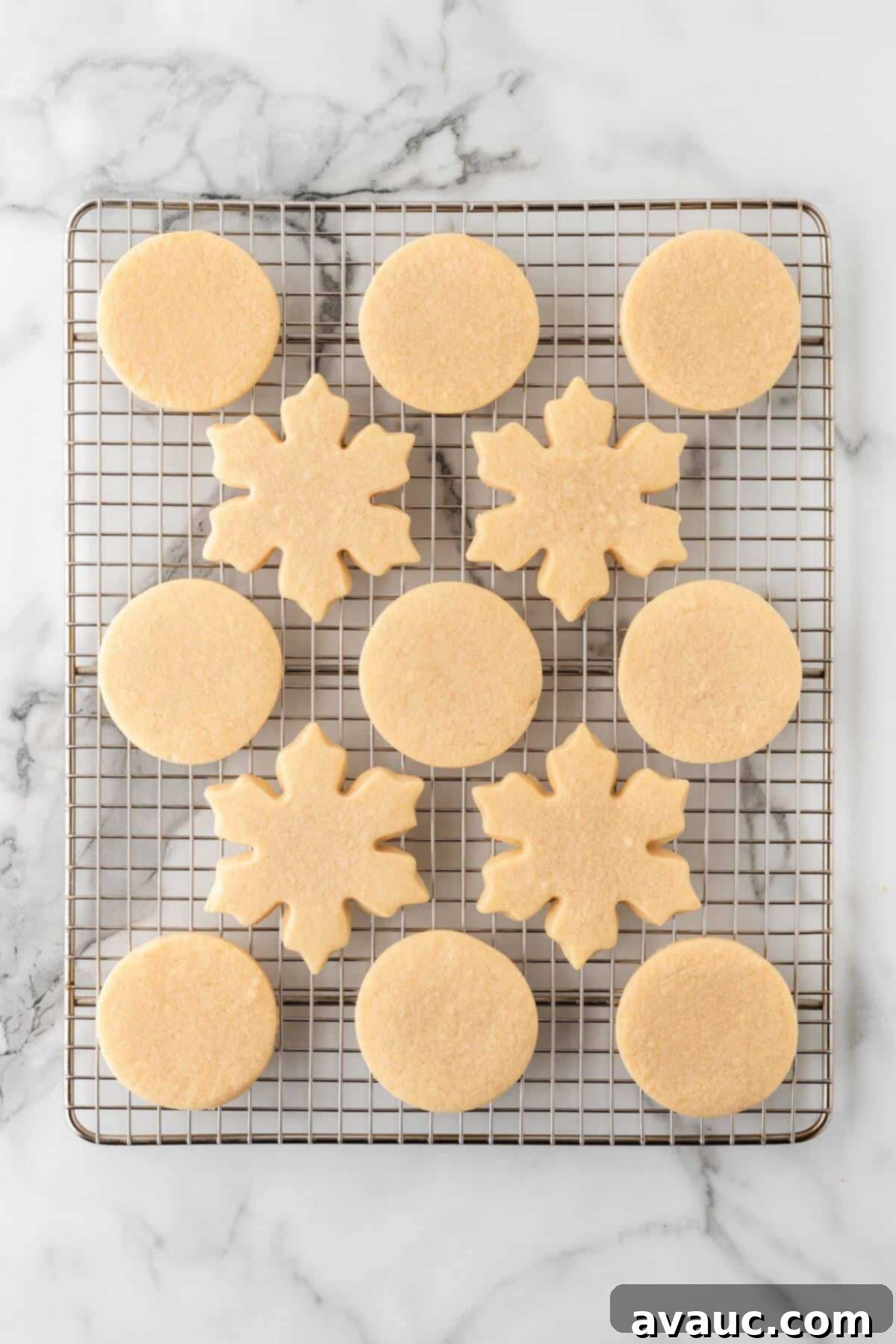 Baked sugar cookies cooling on a wire rack after being removed from the oven