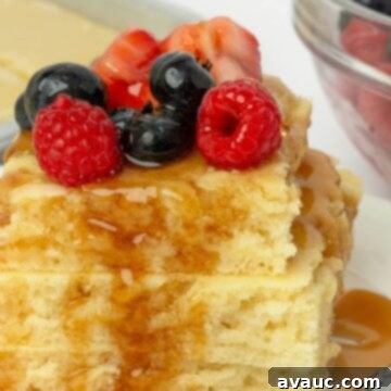 Sheet Pan Pancake Perfection 11 Fluffy sheet pan pancakes adorned with fresh fruit and a generous drizzle of syrup.