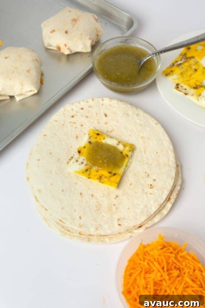 Crispy Breakfast Wraps 7 egg and salsa carefully placed in the middle of a tortilla for breakfast crunchwrap assembly