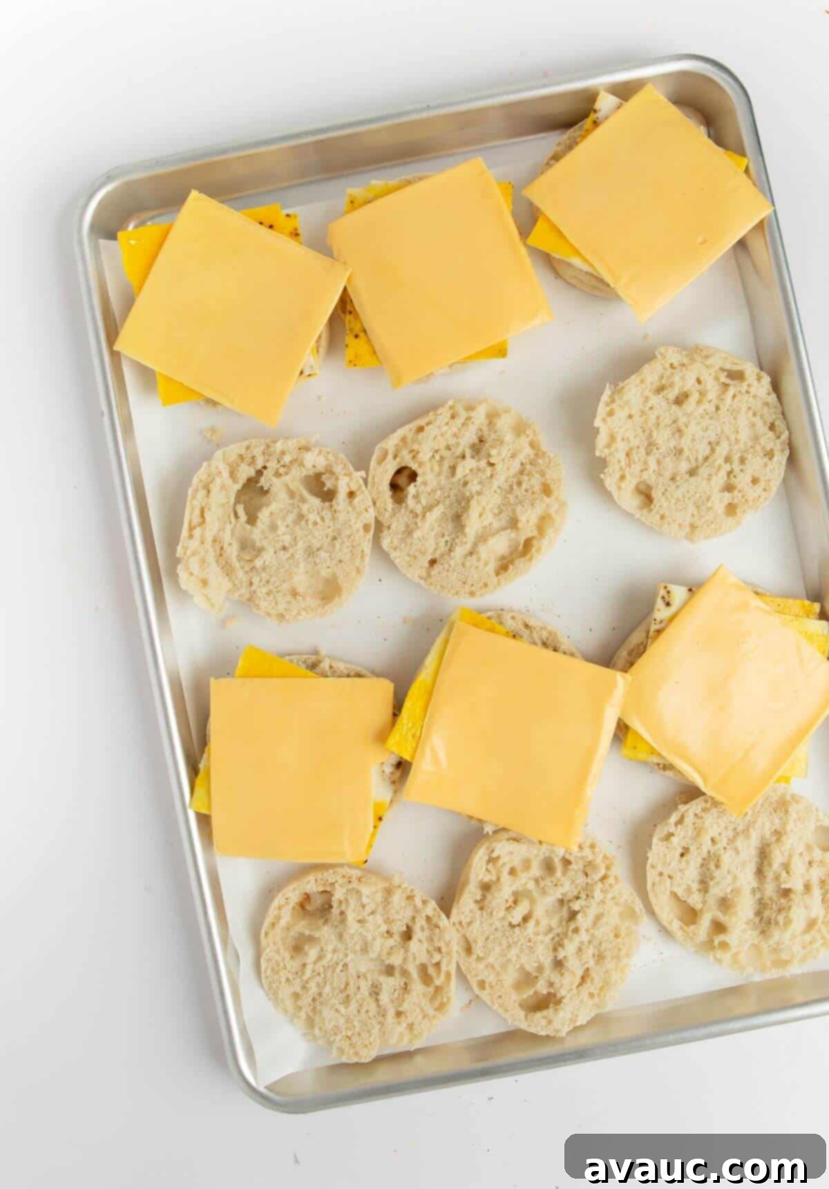 On-the-Go Breakfast Sandwiches 4 English muffins with freshly baked egg patties and cheese slices ready for assembly