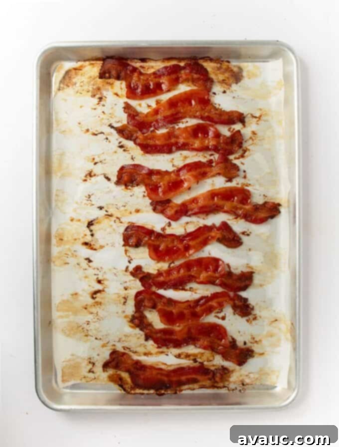 On-the-Go Breakfast Sandwiches 7 Crispy baked bacon strips on a parchment-lined baking sheet, perfect for adding to breakfast sandwiches