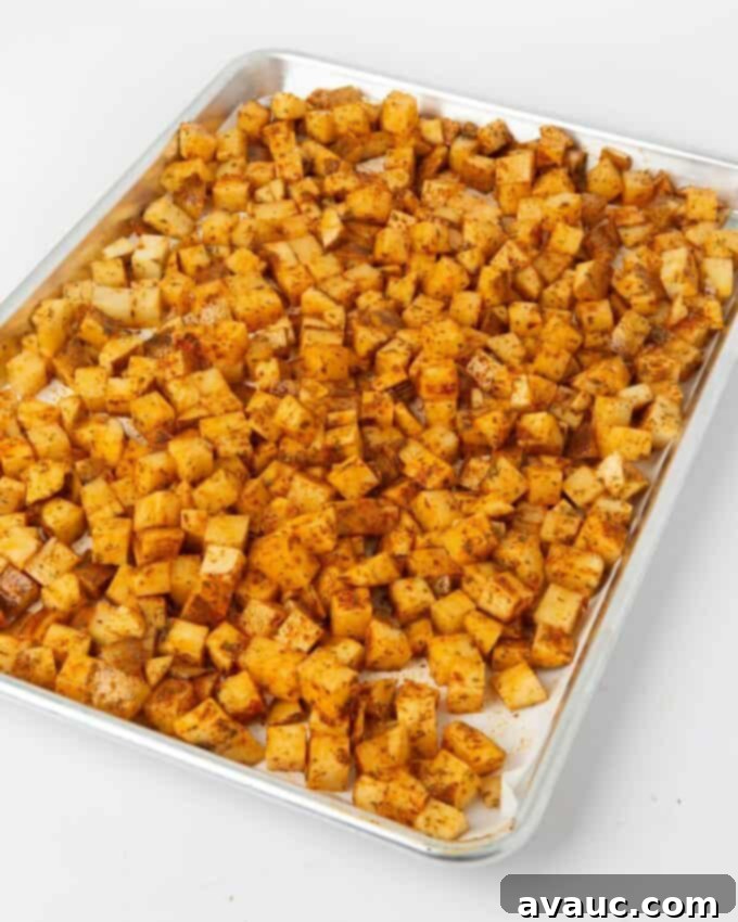 seasoned breakfast potatoes on baking sheet lined with parchment paper
