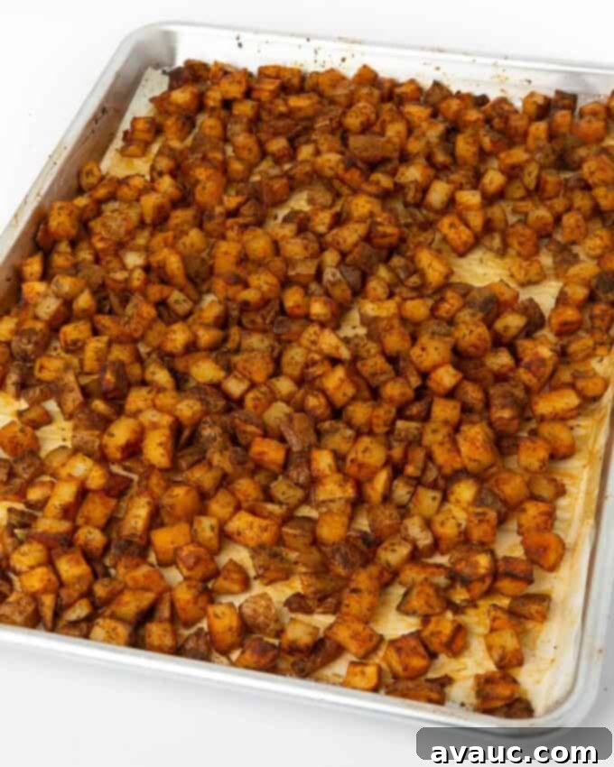 cooked breakfast potatoes on baking sheet with parchment paper