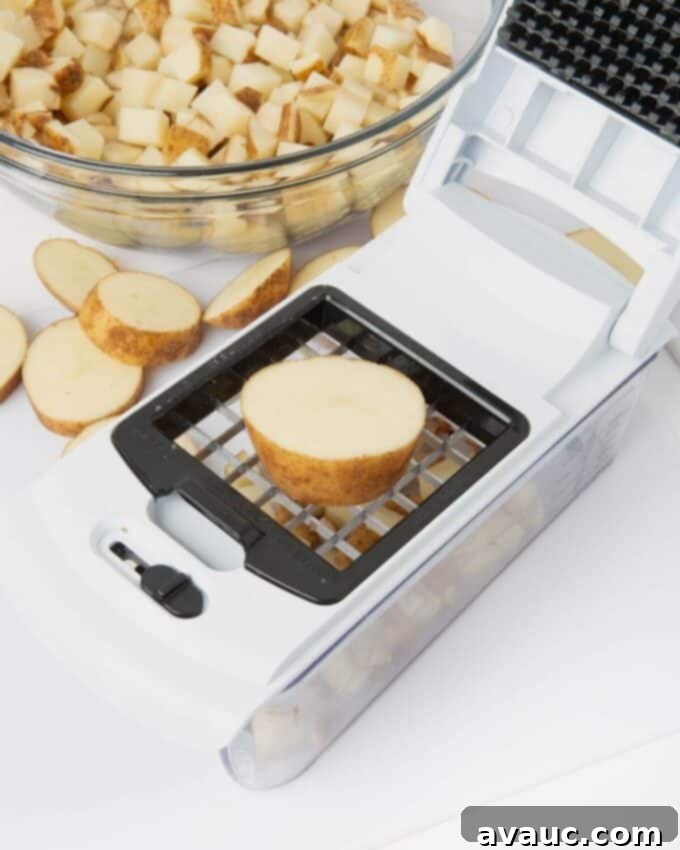 vegetable chopper cutting russet potato into sqaures