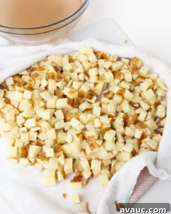 potato cubes drying on paper towel after soaking in ice bath