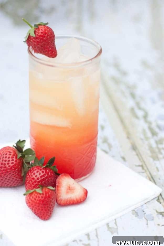 Non-Alcoholic Summer Spritzer with Orange Juice, Lemon-Lime Soda, and Grenadine for a quick and easy refreshing drink. Design Eat Repeat