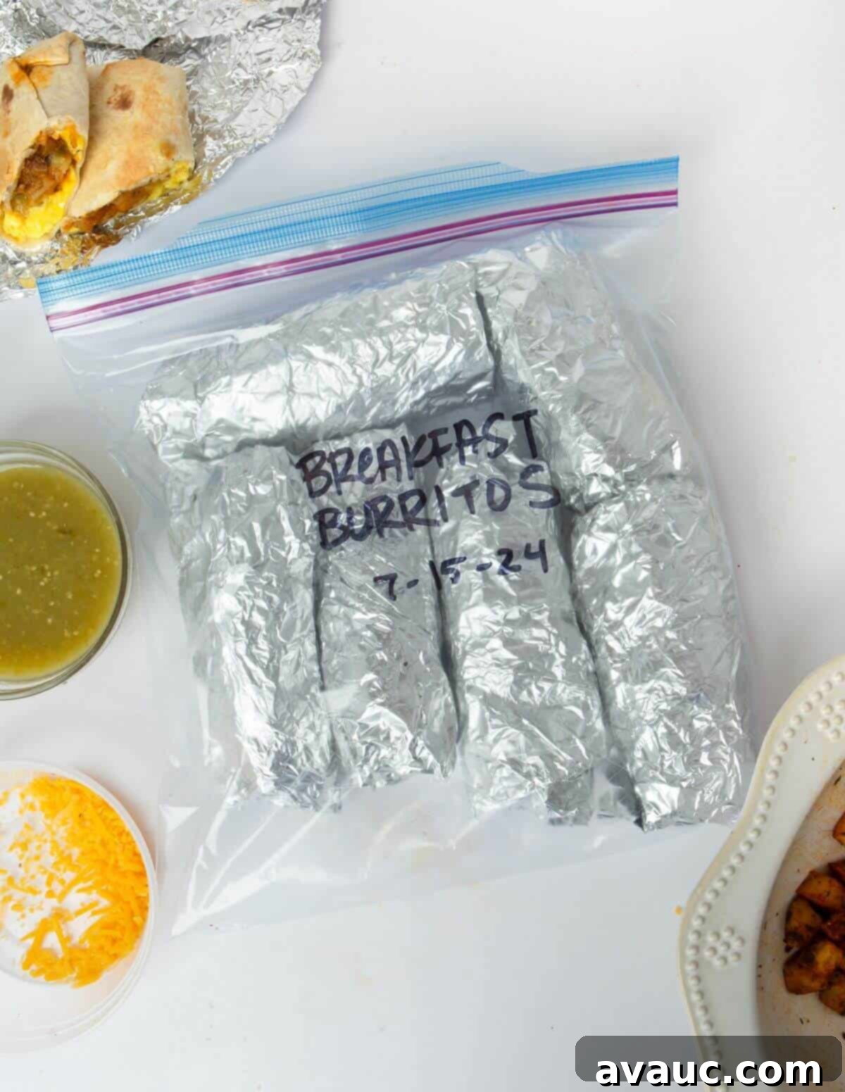 frozen make-ahead breakfast burritos wrapped in tin foil and stored in a freezer bag