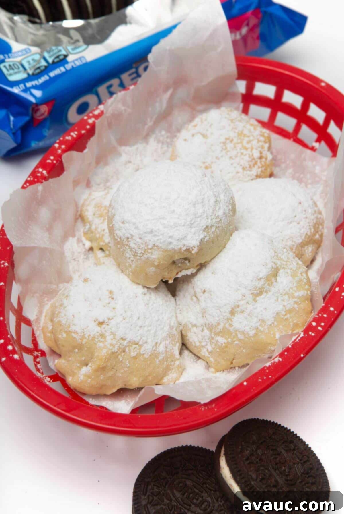 Ultimate Air Fried Oreos 3 Red basket filled with air fried Oreos, lightly dusted with powdered sugar.