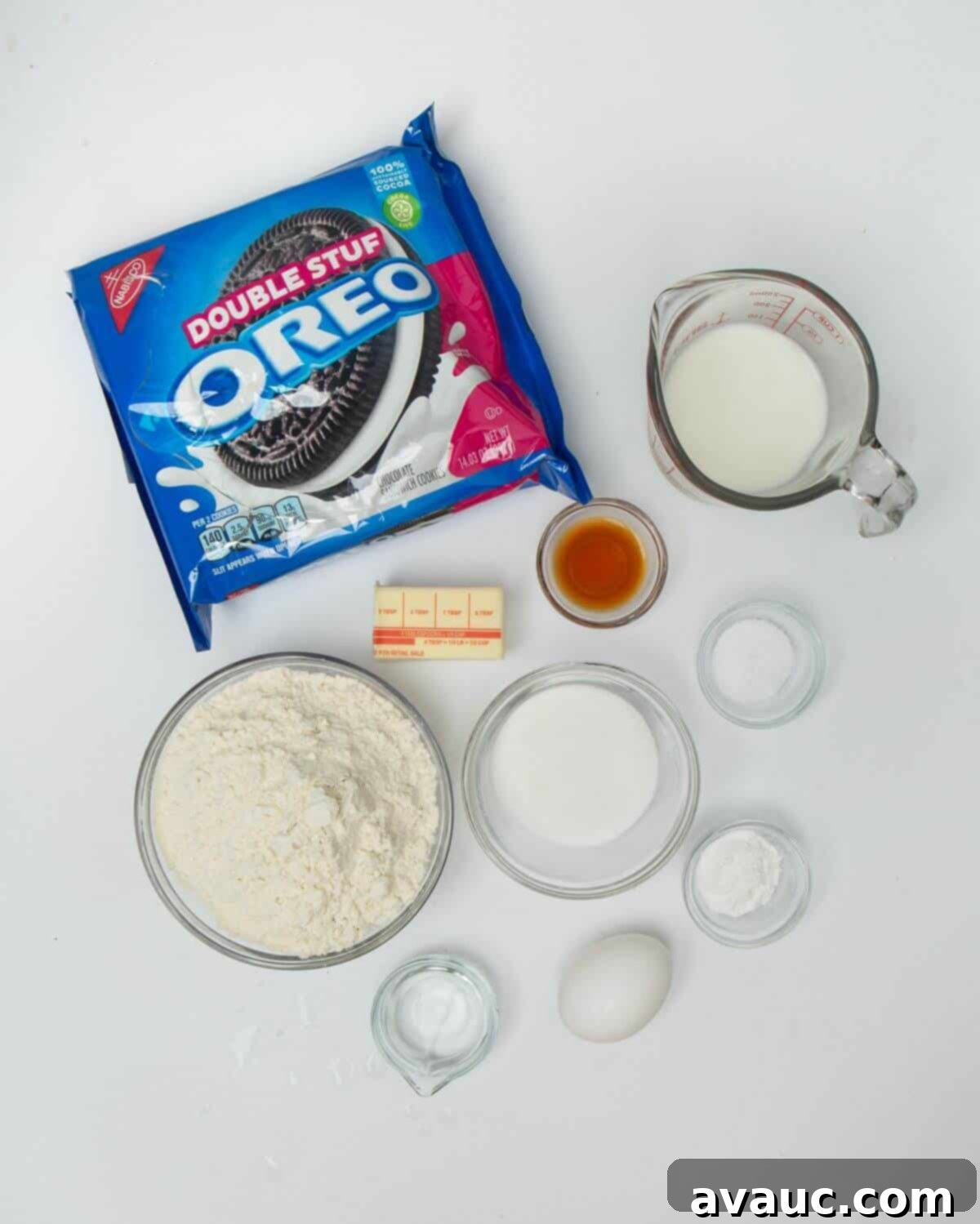 Ultimate Air Fried Oreos 4 Ingredients for air fried Oreos laid out on a marble surface: flour, sugar, baking powder, salt, egg, vanilla, butter, milk, water, and Oreos.