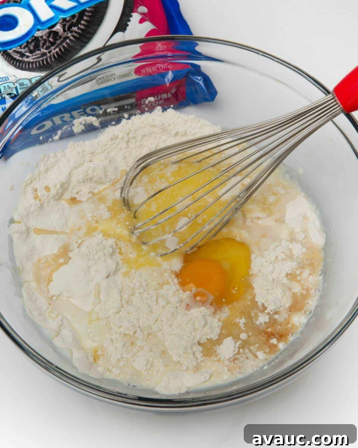 Ultimate Air Fried Oreos 5 Whisking dry ingredients for air fried Oreo batter in a glass bowl.