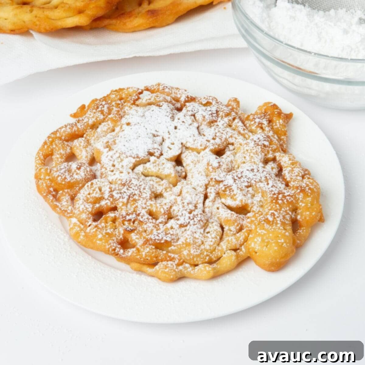Taste of the Fair at Home 1 funnel cake with powdered sugar on white plate
