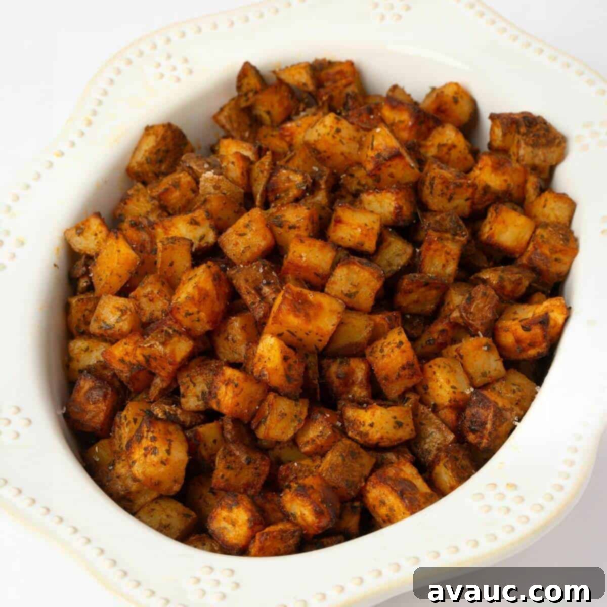 Oven roasted crispy breakfast potatoes in a large serving bowl, perfectly golden brown and seasoned.