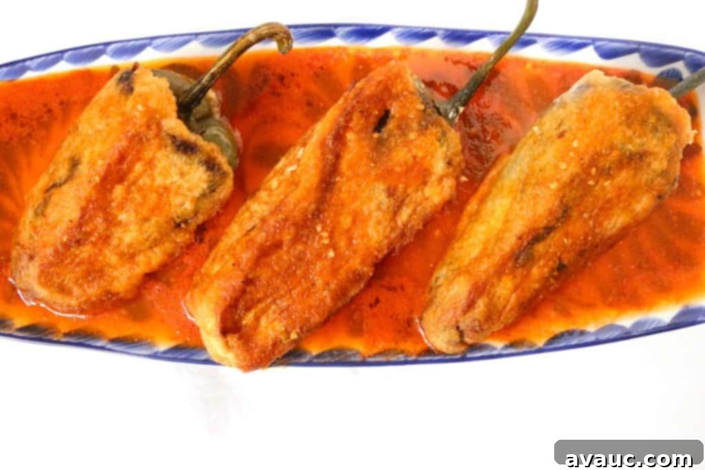 Bacon and Ground Beef Chiles Rellenos served with tomato salsa and rice
