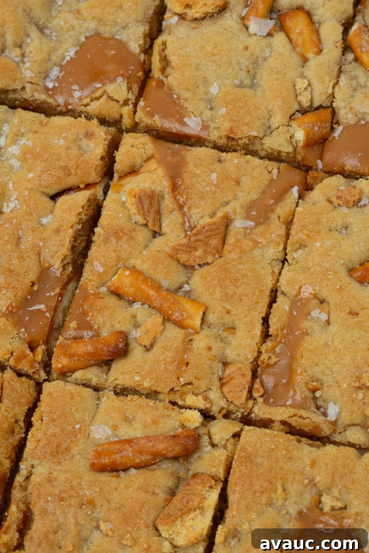 close-up of baked caramel apple kitchen sink cookie bars showing texture of caramels and pretzels