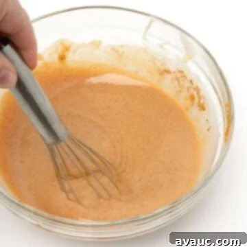 Handcrafted Pumpkin Spice Syrup 9 Homemade pumpkin spice sauce mixed in glass bowl with whisk