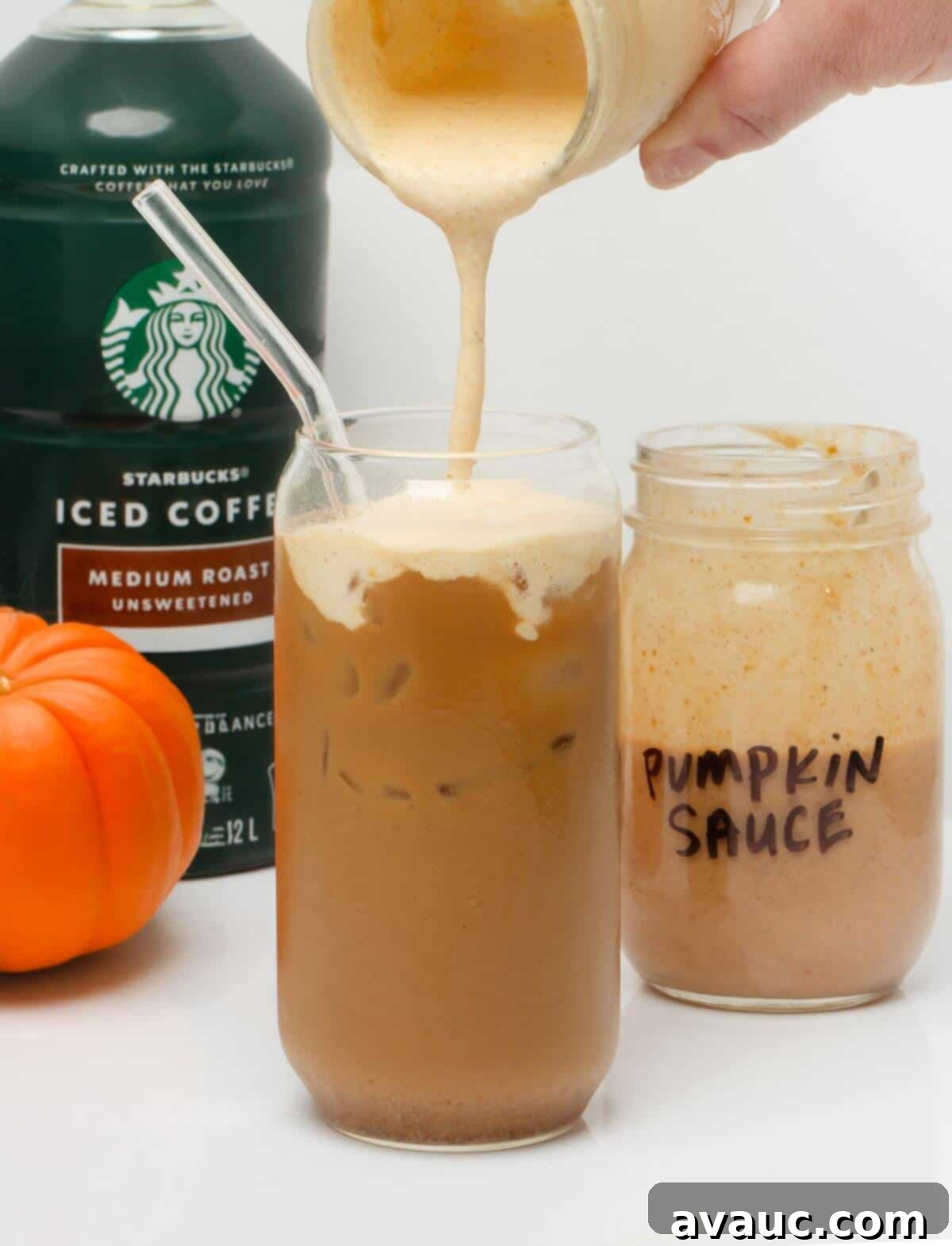 Handcrafted Pumpkin Spice Syrup 8 Pouring pumpkin cold foam, made with the homemade pumpkin sauce, on top of a pumpkin cream cold brew in a glass.