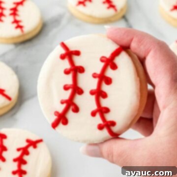 Close-up of a decorated baseball sugar cookie with red stitches