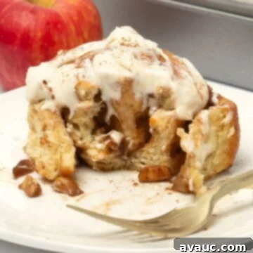 Quick Apple Cinnamon Rolls 11 white plate with apple cinnamon rolls and apple in background