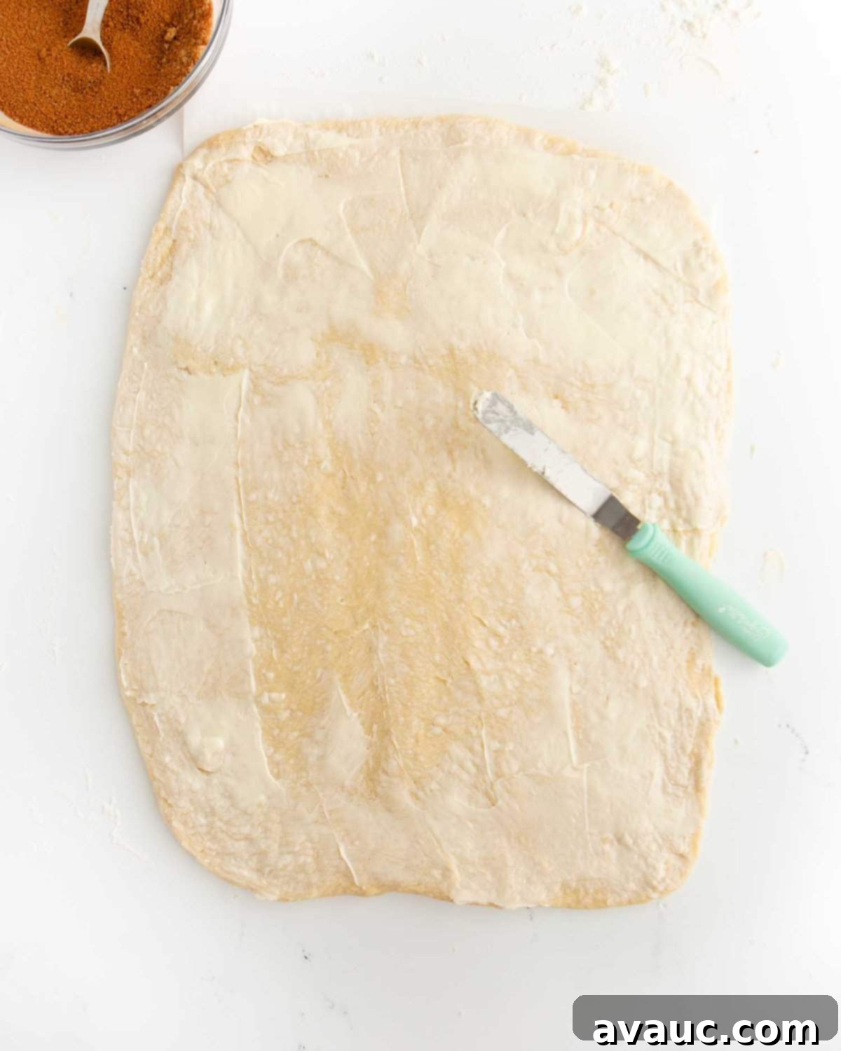 Quick Apple Cinnamon Rolls 7 cinnamon roll dough spread with butter, ready for the filling