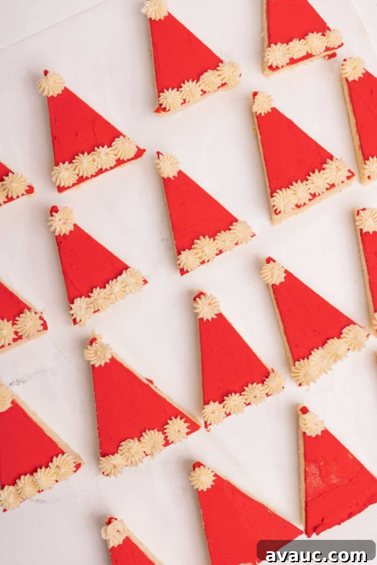 Festive Santa Hat Cookie Bars 2 santa hat sugar cookie bars decorated on parchment lined sheet
