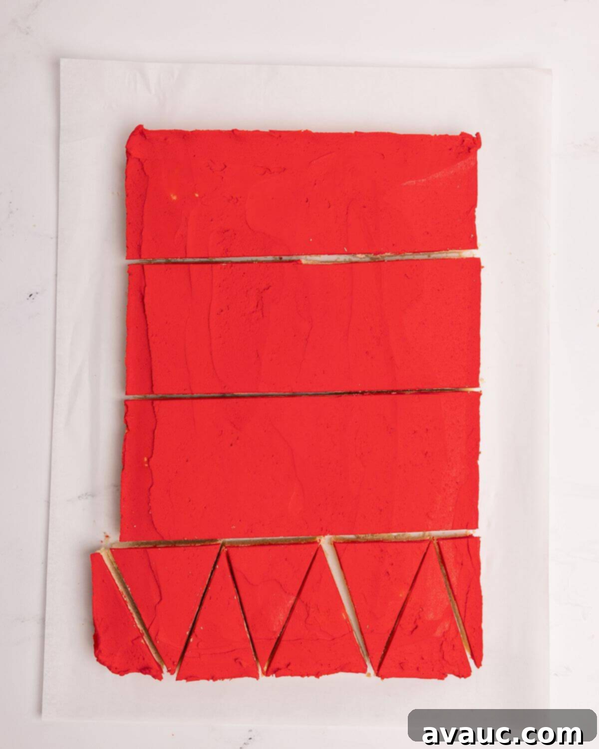 Festive Santa Hat Cookie Bars 10 cutting frosted sugar cookie bars into individual triangles