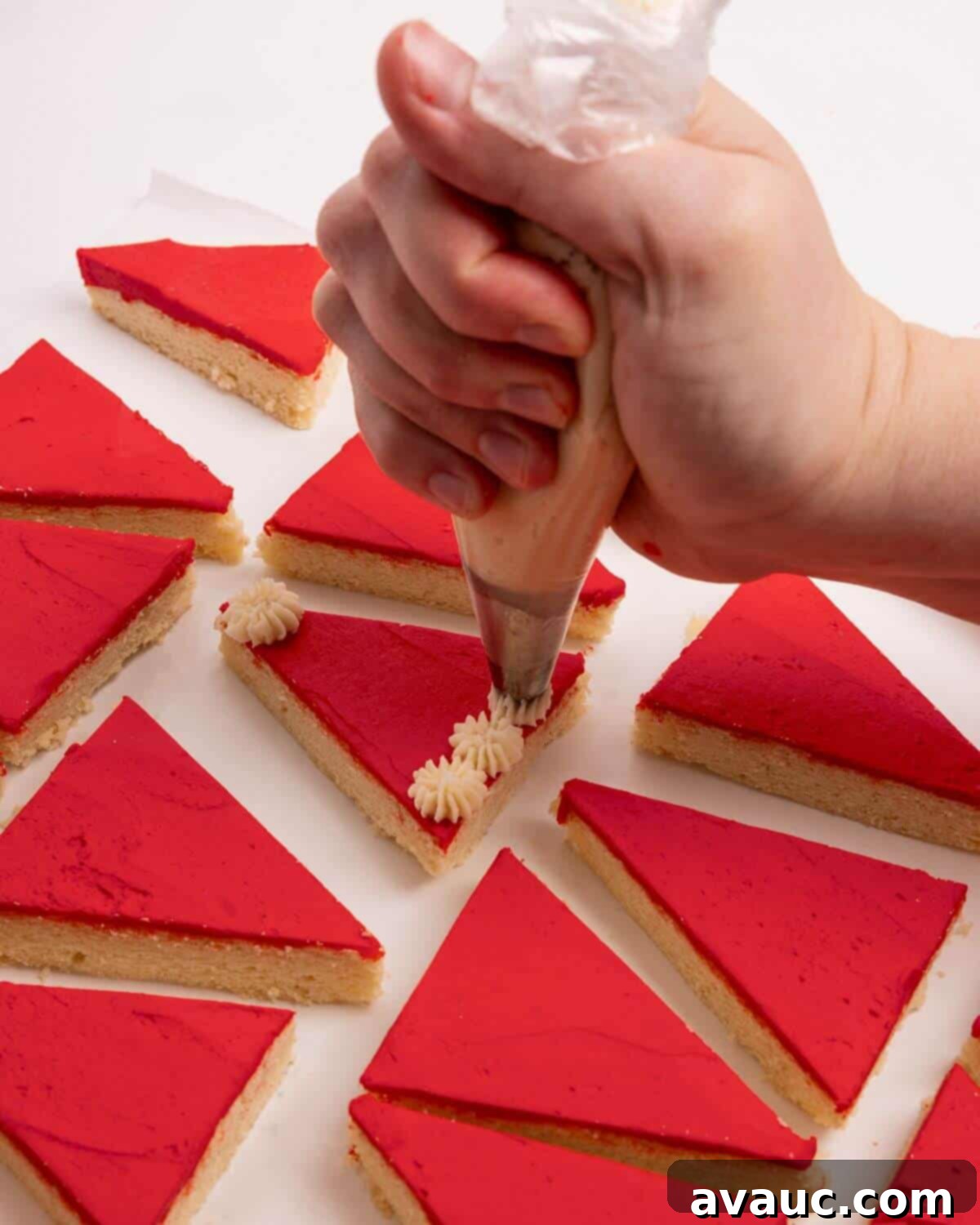Festive Santa Hat Cookie Bars 11 adding white pompoms to red sugar cookie bars