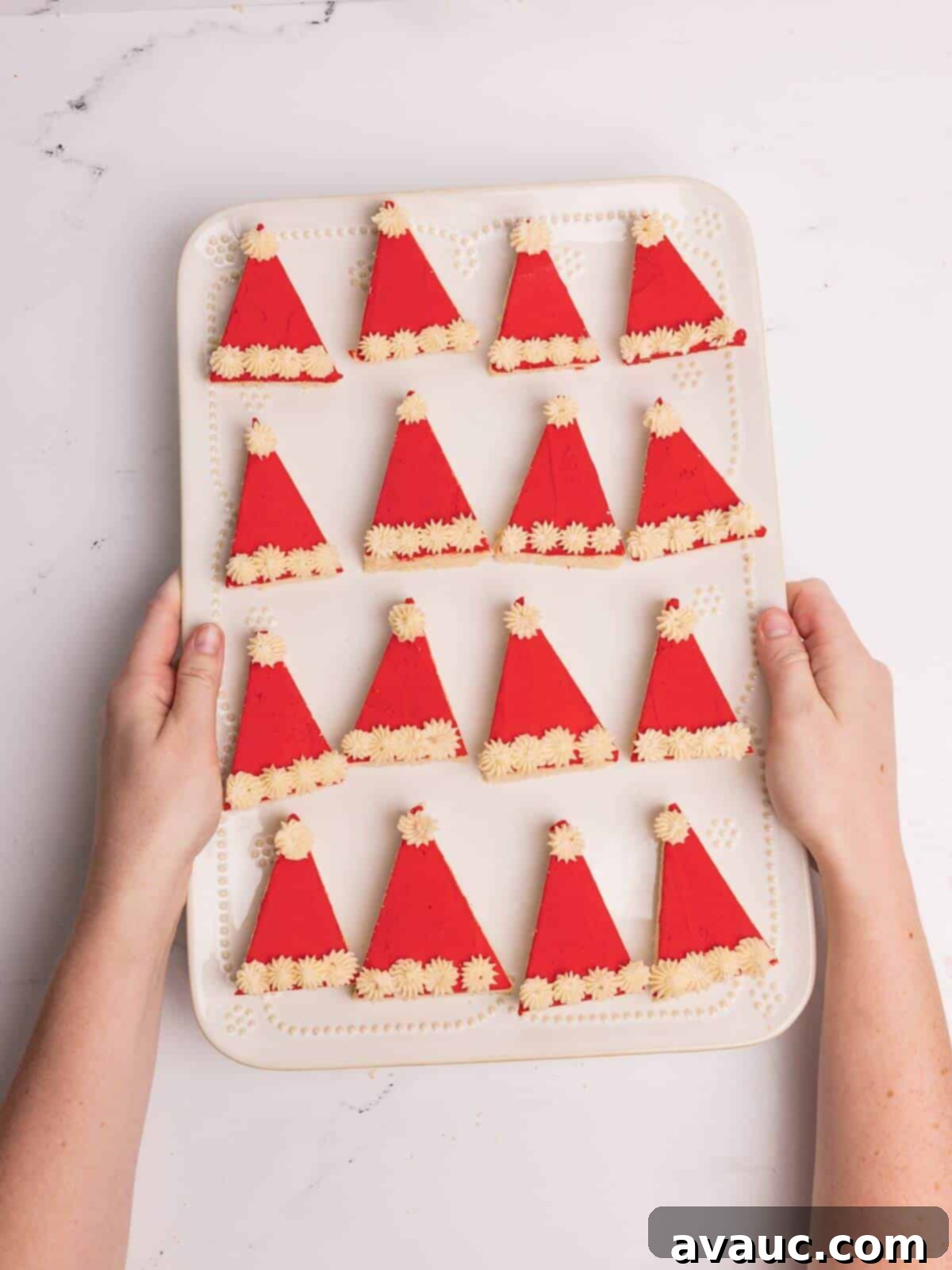 Festive Santa Hat Cookie Bars 12 santa hat sugar cookie bars on white serving tray