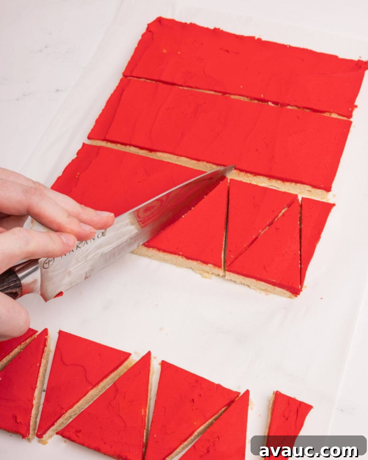 Festive Santa Hat Cookie Bars 3 cutting santa hat sugar cookie bars into triangles