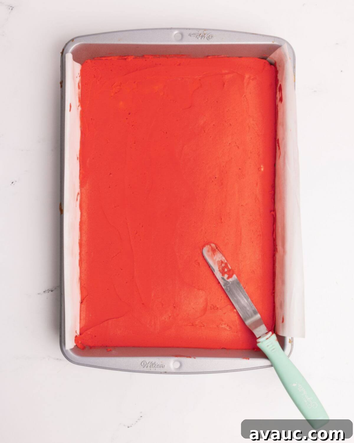 Festive Santa Hat Cookie Bars 7 red frosting spread over sugar cookie bar