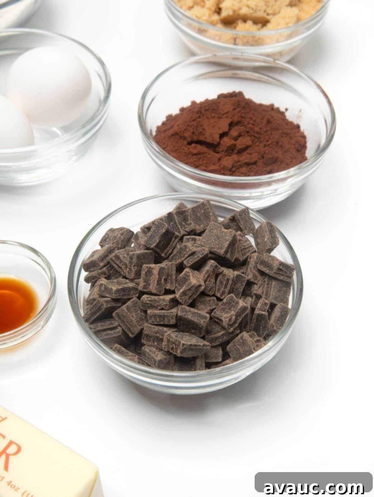 Ingredients for dark chocolate cookies laid out in mini glass bowls.