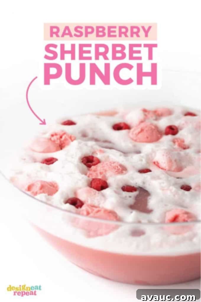 Large punch bowl filled with vibrant Raspberry Sherbet Punch, ready to serve at a party.