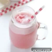 Raspberry Sherbet Punch in a cup with raspberries