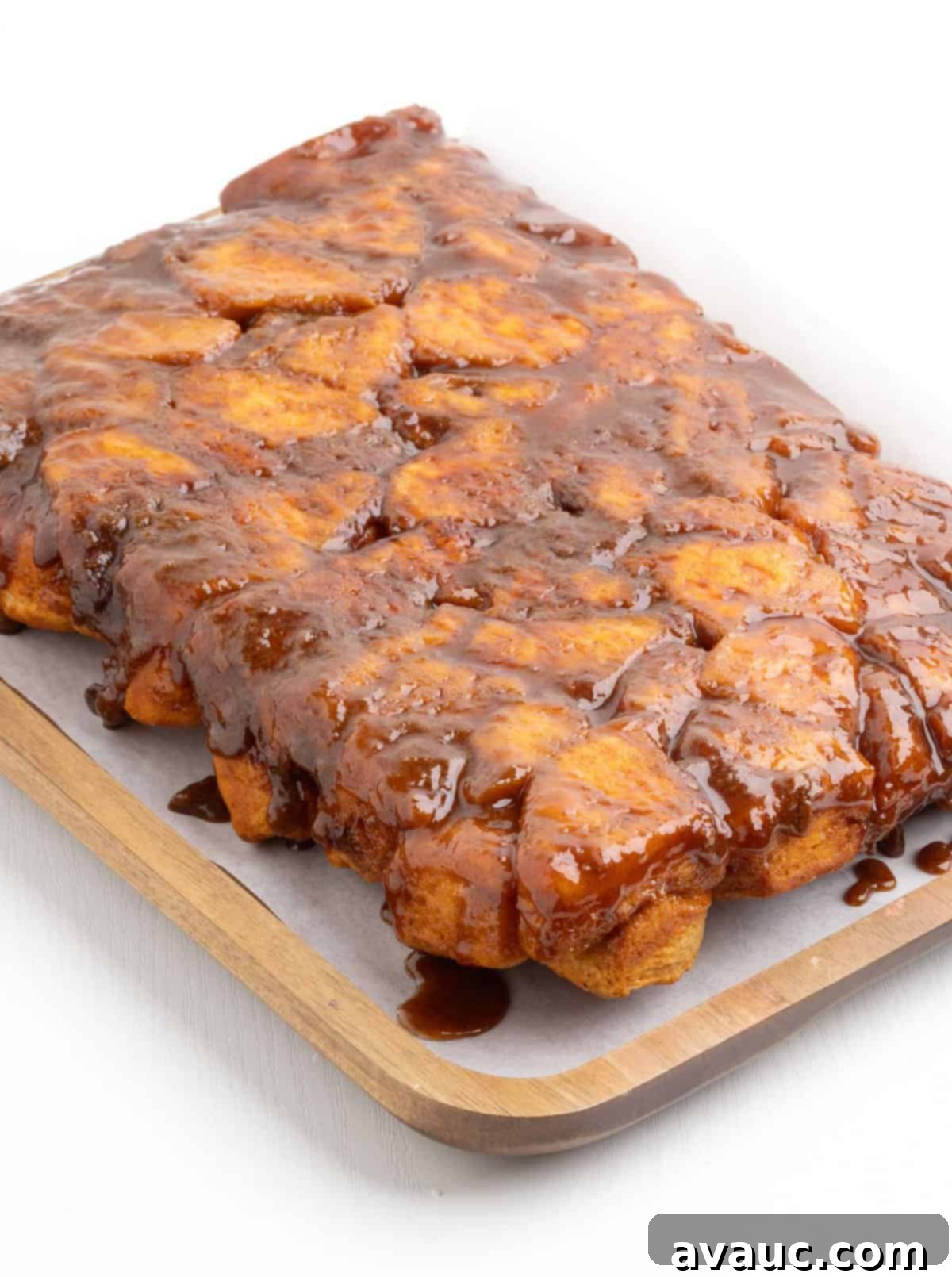 Monkey Bread in a 9x13 Pan 11 Flipped 9x13 butterscotch monkey bread on a serving platter, showing its golden, gooey underside.