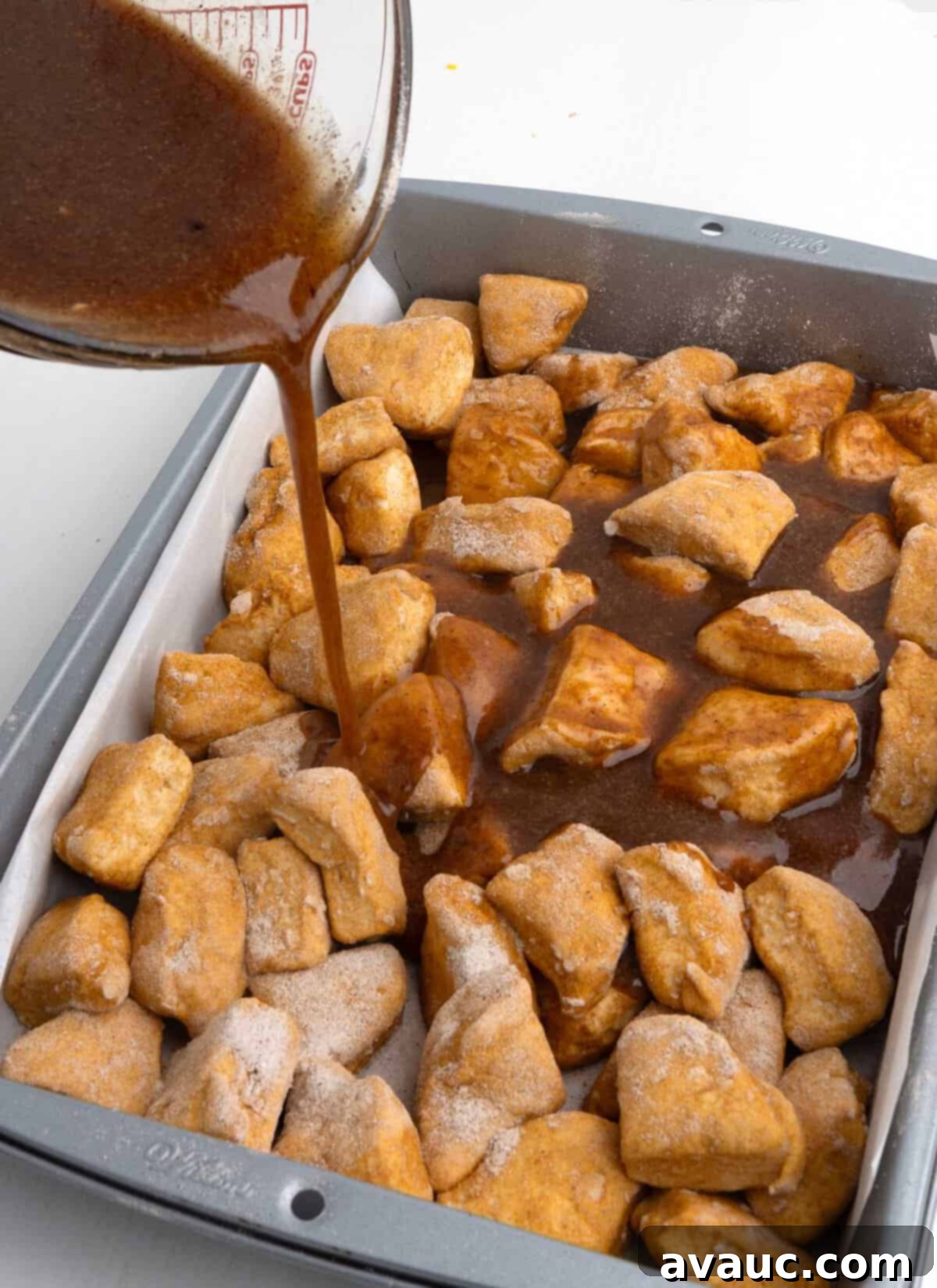 Monkey Bread in a 9x13 Pan 3 Cut canned biscuit dough pieces coated in butterscotch pudding mix and cinnamon in a 9x13 pan, before adding glaze.