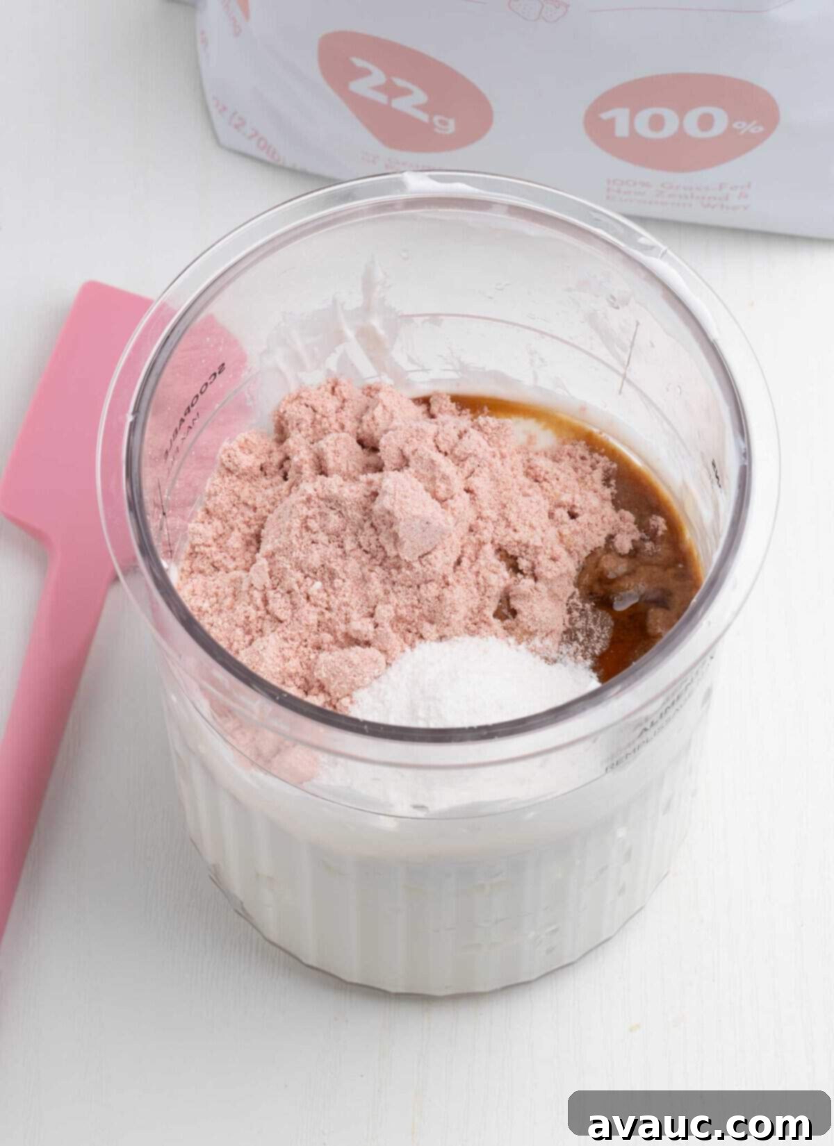 Ninja Creami Strawberry Protein Frozen Yogurt 5 Ninja Creami pint container filled with mixed strawberry yogurt base before freezing