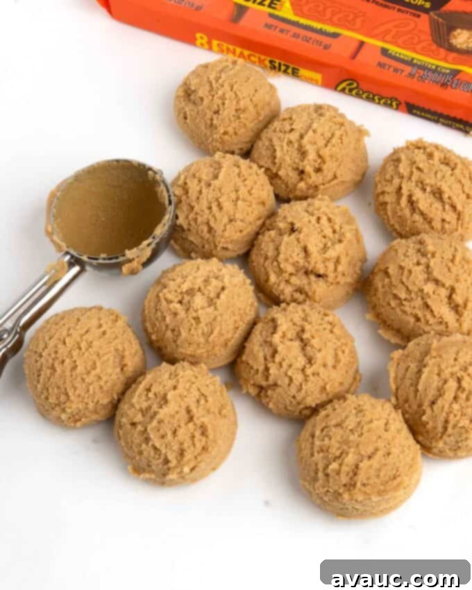 Reese's Peanut Butter Core Cookies 7 Scoops of peanut butter cookie dough on a parchment-lined baking sheet