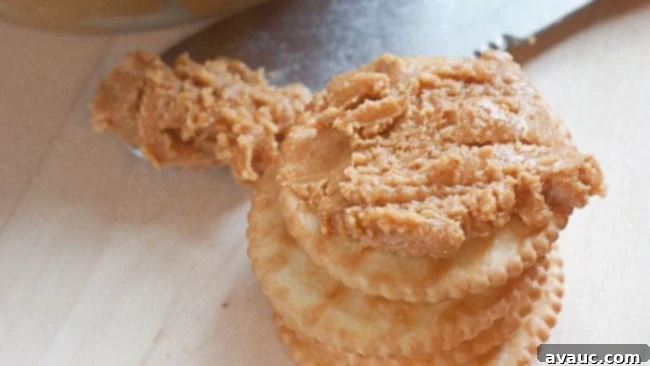 Close-up of homemade peanut butter with olive oil and honey in a jar.