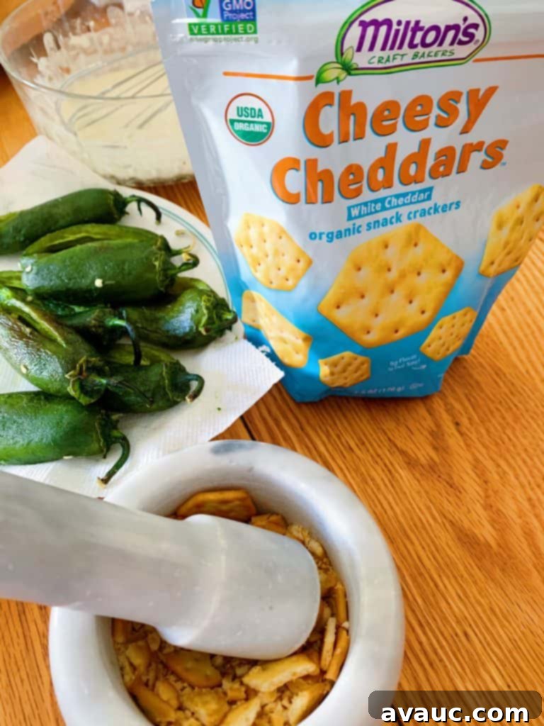 Preparing the jalapeños by rolling them in Milton's cracker crumbs and then dipping in a light batter for an extra crispy Mexican appetizer.