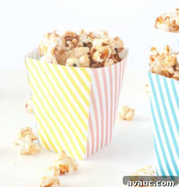 Pink, yellow, and blue striped free printable popcorn box template filled with kettle corn for birthday, circus party, baby shower.