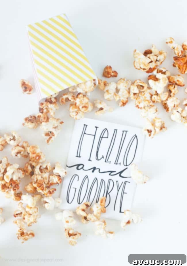 Pink, yellow, and blue striped free printable popcorn box template filled with kettle corn for birthday, circus party, baby shower with hello and goodbye card.